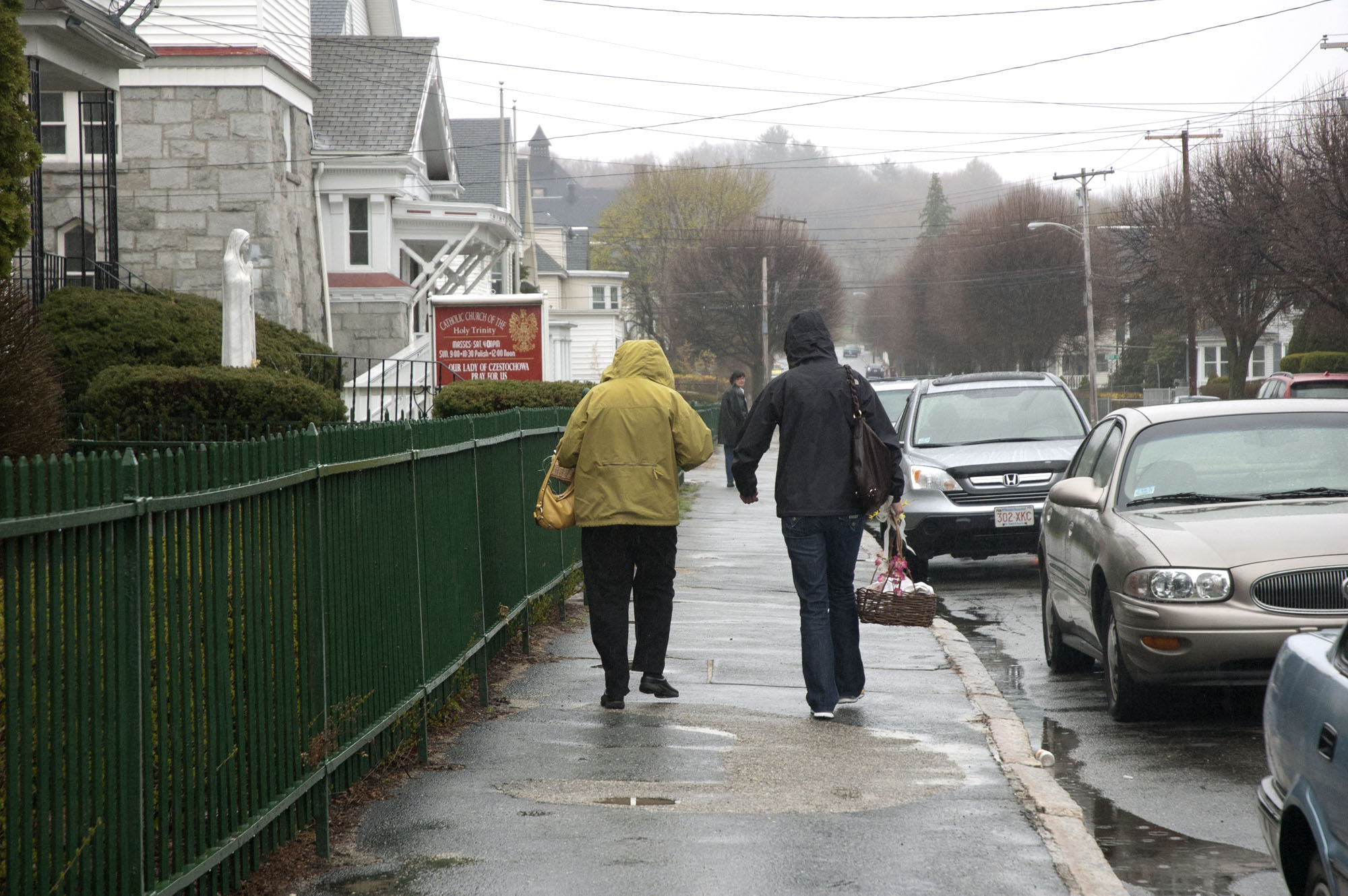 Two parishioners walking home with their blessed food.