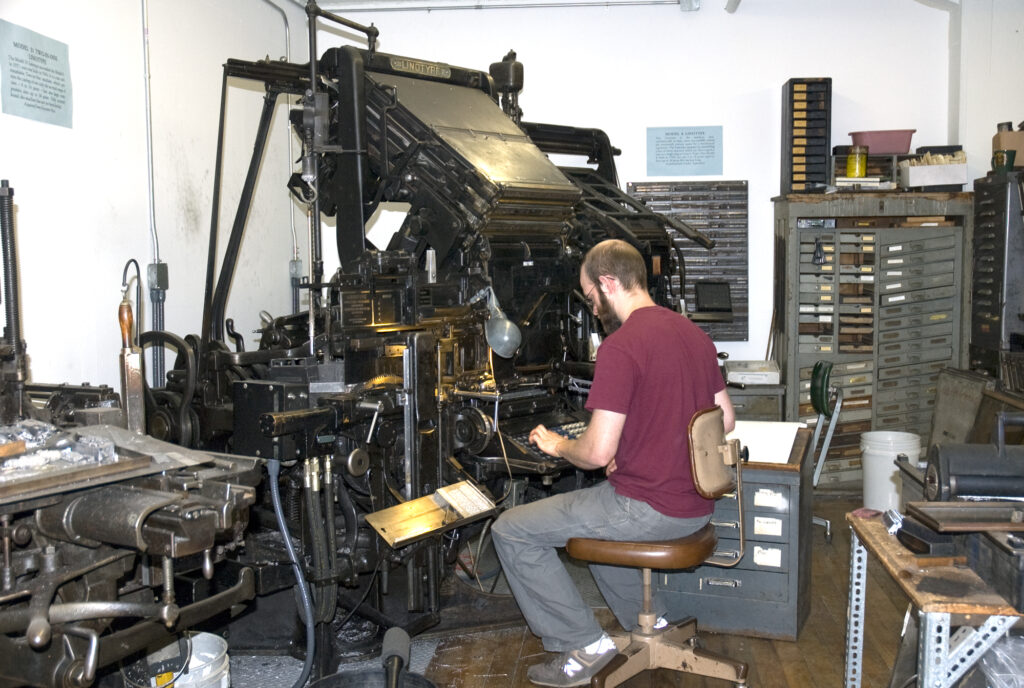 Jesse Marsolais working at the Linotype during his apprenticeship to John Kristensen.