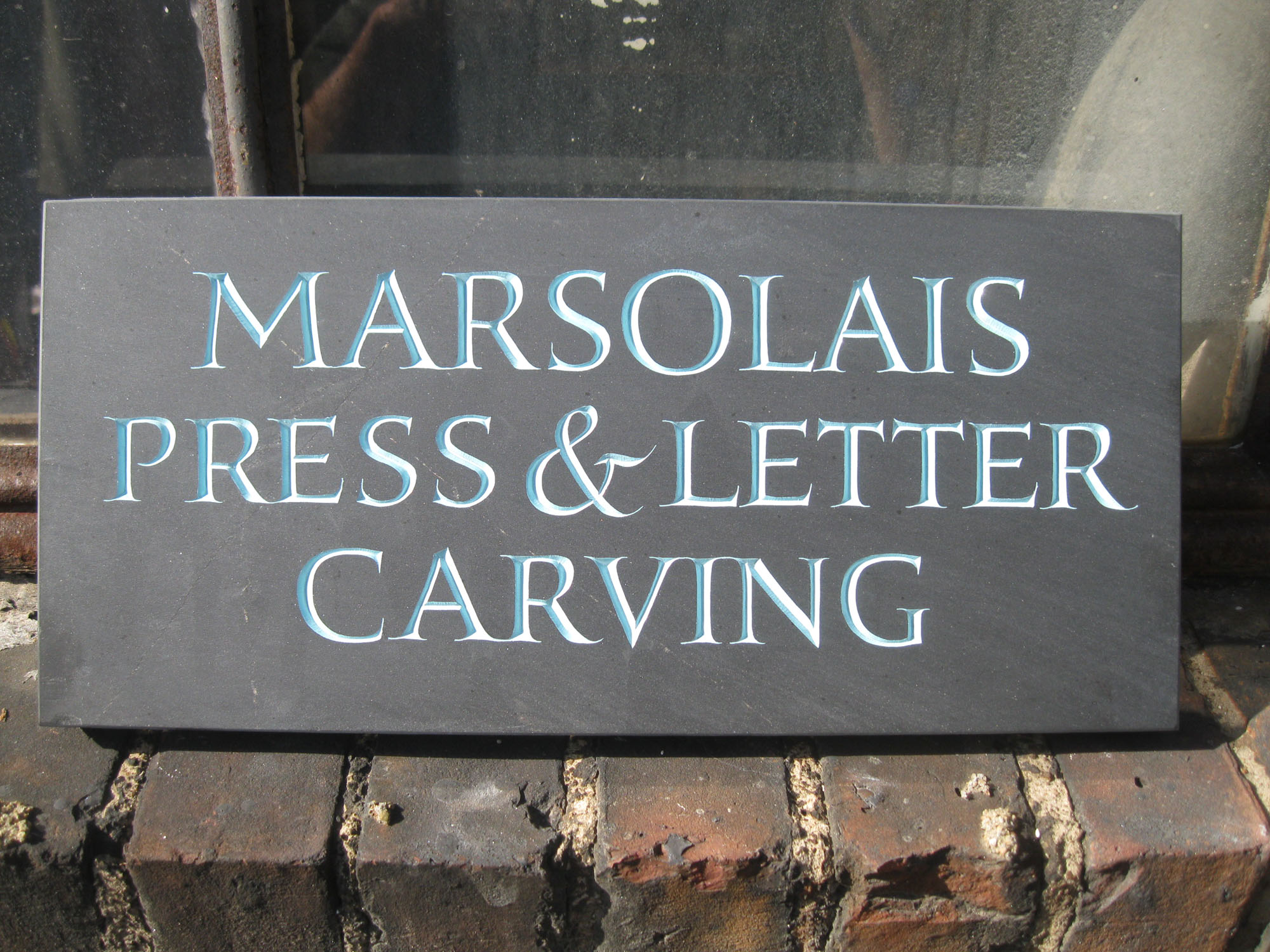 Sign for Jesse Marsolais shop.