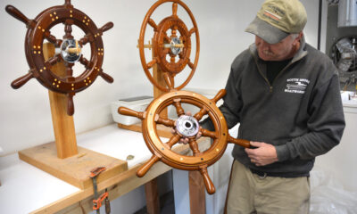 Bob Fuller holding one of his ship’s wheels.