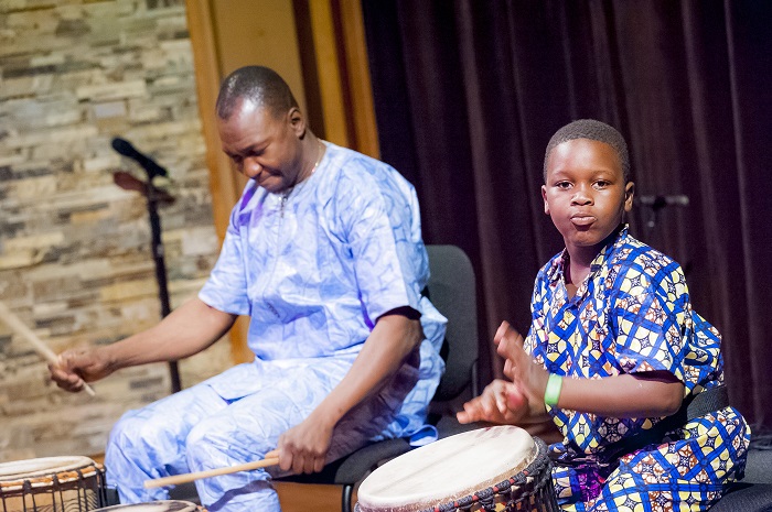 Sidi Joh Camara on and his son Tiemoko playing djembe.