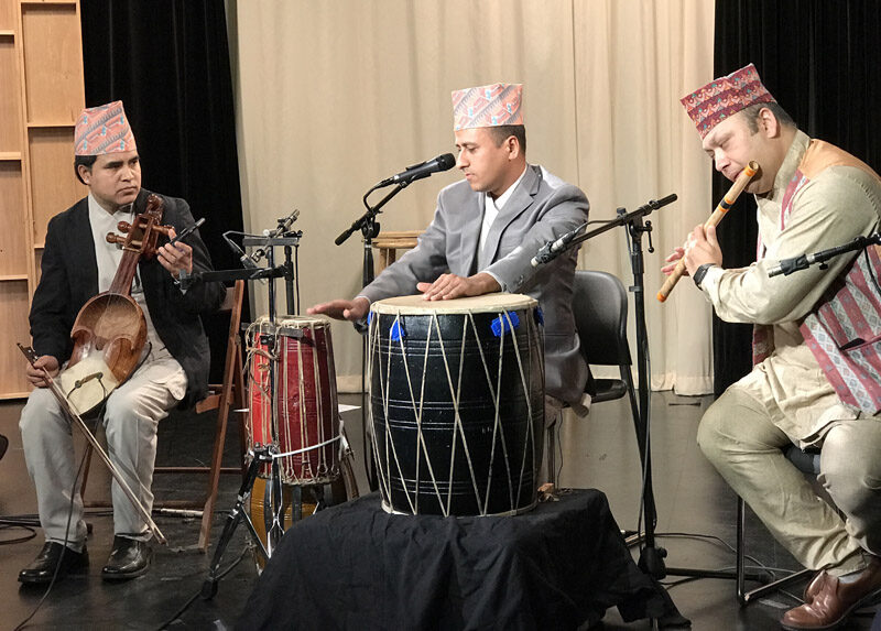 Nepali group of three performing.