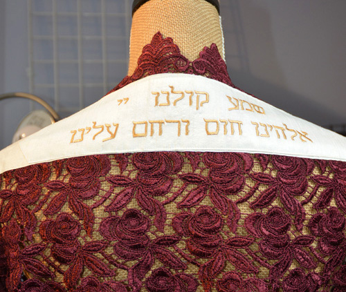 Detail of embroidered attarah saying, "Hear our voices" on tallit by Amy Lassman.