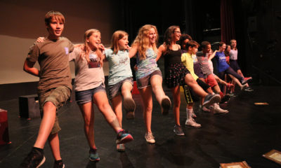 Young people rehearsing on stage at Wheelock Family Theatre