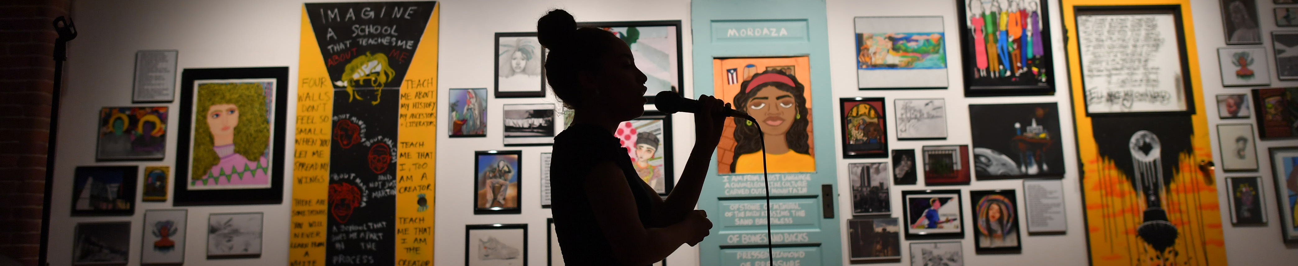 Young woman performing at Elevated Thought gallery