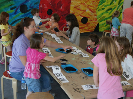Family doing an art activity at Eric Carle Museum