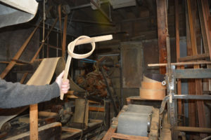 Jay holding a strip of oak that has been steamed and tied in a knot