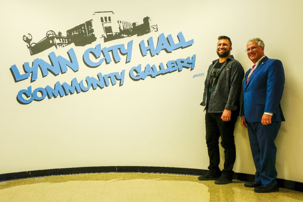 Artist Grimdrops poses with Mayor Thomas McGee in the new Community Gallery which will also still hold community meetings.