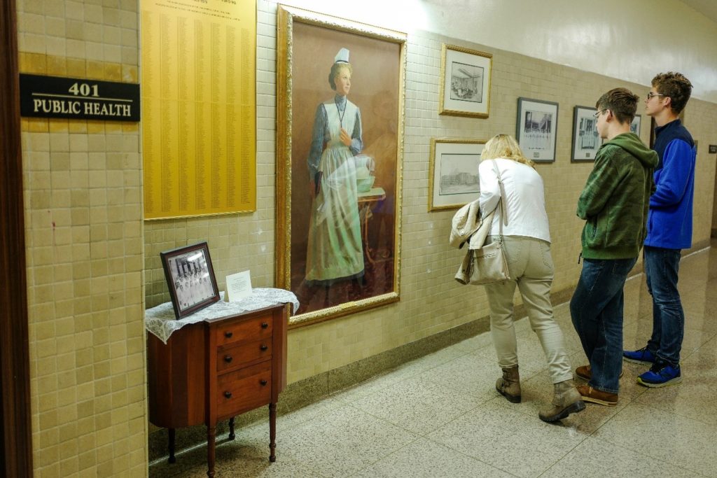 Attendees peering at the photos from the former Lynn Hospital which is set just next to the entrance of the Public Health Department.