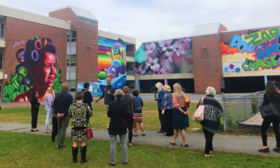 Attendees of the 2019 Cultural District Convening take in some of Worcester's murals.