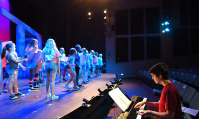 Young people rehearse on the stage of Greater Boston Stage Company in Stoneham, MA.