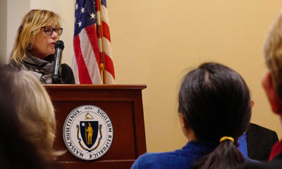 Anita Walker speaking at a podium at the State House