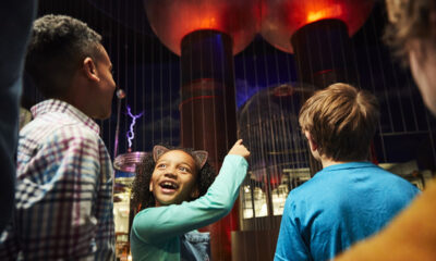Children watching a demonstration of the tesla coils at the Museum of Science