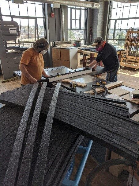 Technocopia members prepare to cut PPE wood shop foam.