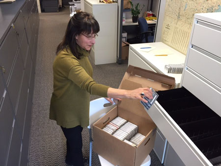 Maggie boxing up cassettes.