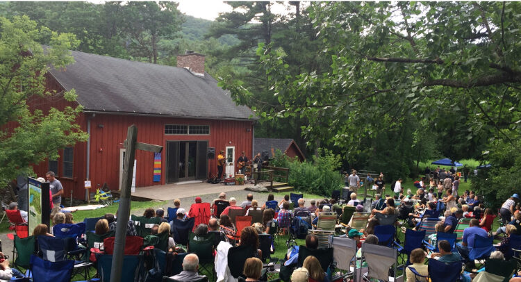 People gathered on the lawn for an outdoor concert outside the Pleasant Valley Barn