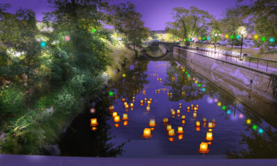 Lanterns float in a Lowell canal in the evening