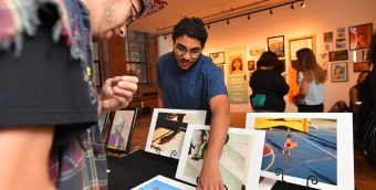 People viewing artwork table in a gallery