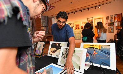 People viewing artwork table in a gallery