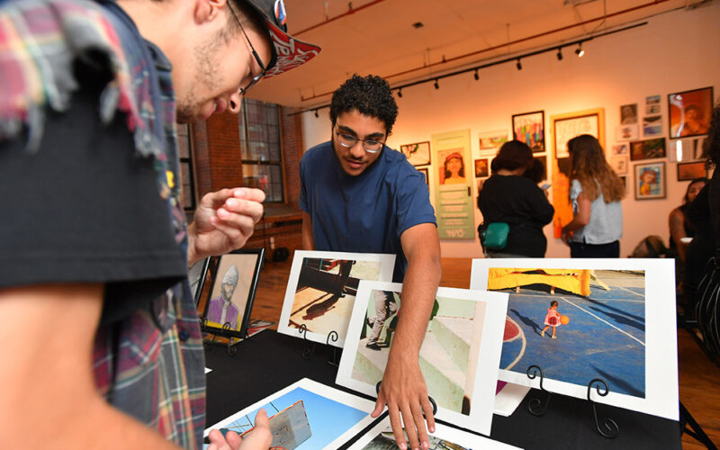 People viewing artwork table in a gallery