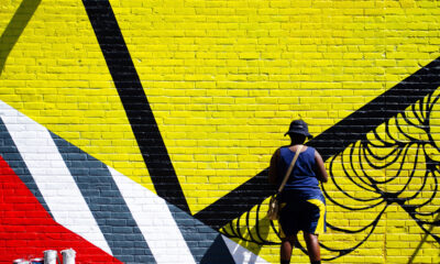 a person faces a brightly colored mural in Springfield