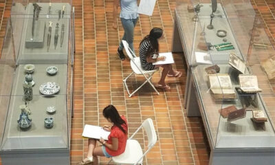 3 people sketching in the Armenian Museum Gallery.
