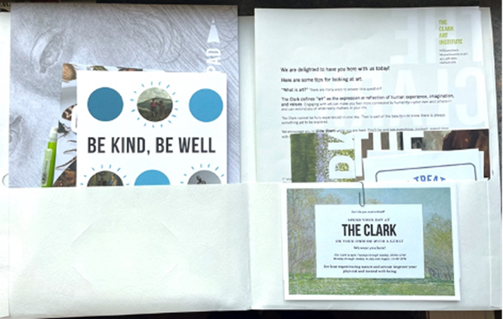 an open pocket folder. Both sides contain printed pieces to introduce museum visitors to their wellness offerings