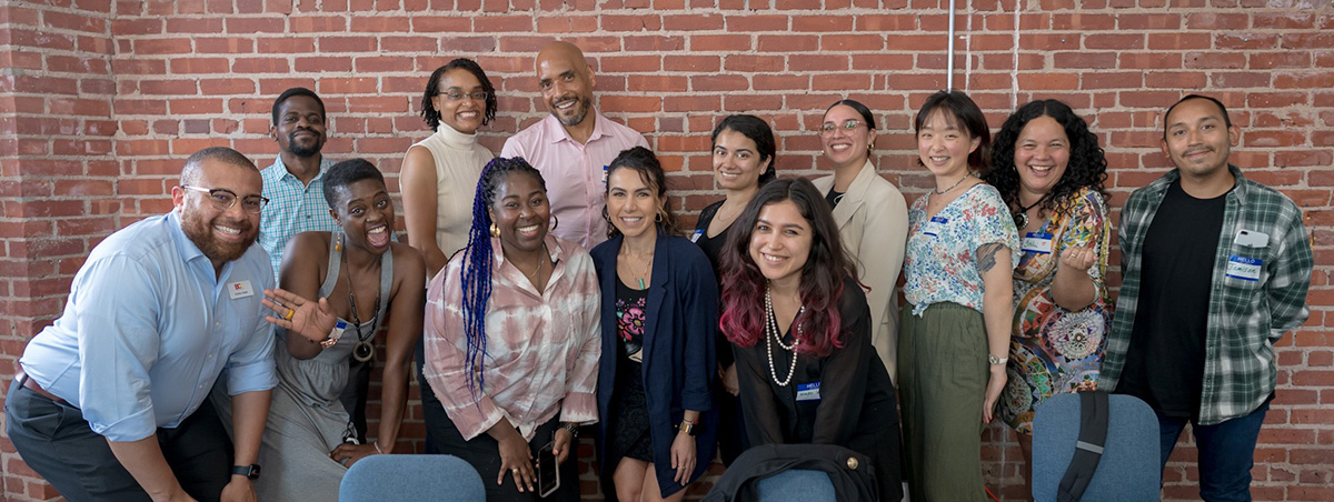 a group photo of 13 arts administrators and artists of color