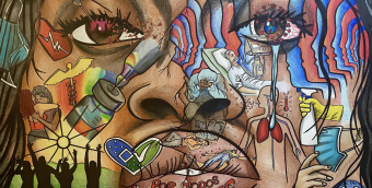 Photo detail of a mural depicting a face and over the face are images evoking public health and community and encouragement to get vaccinated