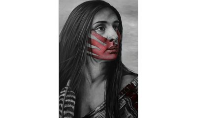 black and white photo of a Native woman with a red-painted handprint over her mouth and face - by Nayana LaFond