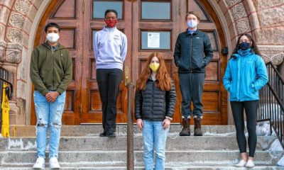 Amherst High School students involved with town government through service in various committees stand on the steps of Town Hall.Photo Credit: Daily Hampshire Gazette.