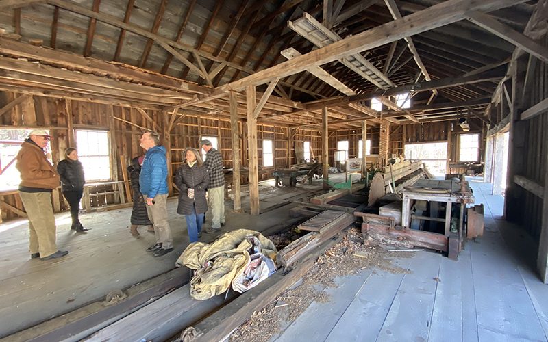 People viewing the unfinished main floor of the North Leverett Sawmill