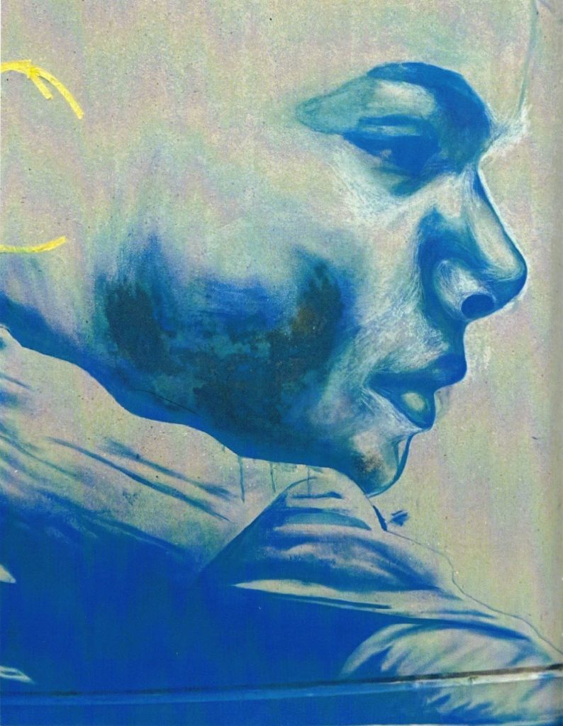 photo of part of a mural in-progress. Different shades of the same blue paint are used to create a boy's profile