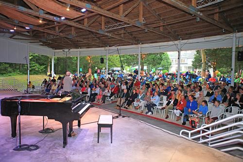 Audience of people behind a stage with a piano at the South Shore Conservatory of Music