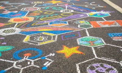 photo of a detail of an intricate chalk drawing with many colors filling hexagonal shapes