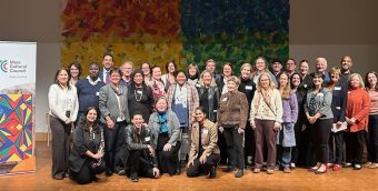 group photo of about 3 dozen attendees at the grant celebration