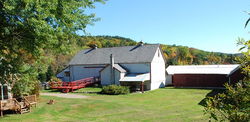 View of building and open lawn on Double Edge Theatre's campus