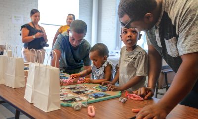 photo of young people and their care givers engaged in an craft project during a community STEAM event.