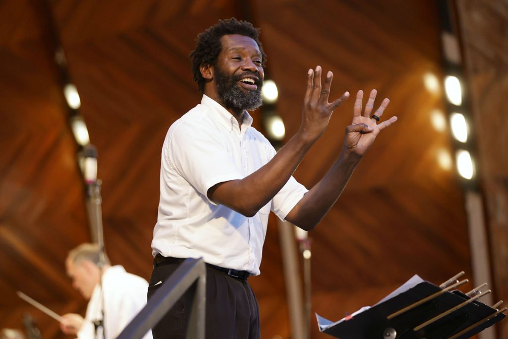 photo of an ASL interpreter signing on the stage of the Boston Hatchshell.