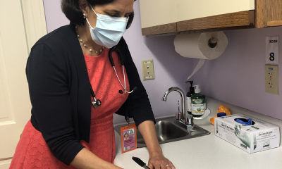 photo of a doctor in an examination room writing an arts prescription