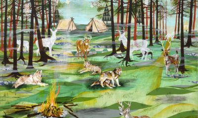 photo of mixed media on panel. A forest scene punctuated by not pine trees and various types of deer, wolves, and owls sprinkled throughout. In the background are 2 canvas pitched tents and a hint of a mountain range behind them.