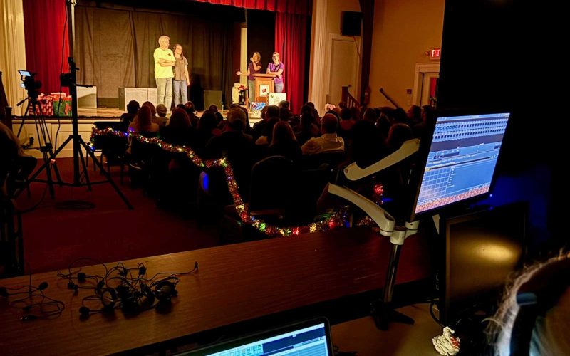 View of packed performance space from behind the sound board