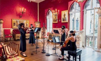 photo of a string quartet giving performance in an ornate room with red walls at the Isabella Stewart Gardner Museum.