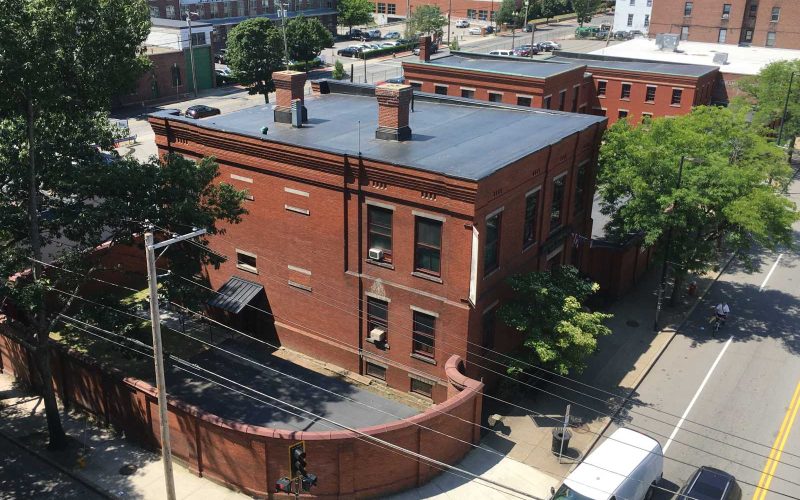 Aerial view of the brick Immigrant City Archives building in downtown Lawrence