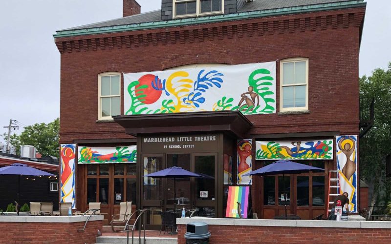 Front façade of brick building with colorful murals