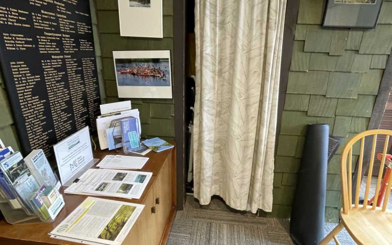 Lobby area with a stand with informational papers at the Nashua River Watershed Association