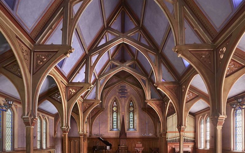 Vaulted ceilings and view of stage from seating in former church at Thacher Hall