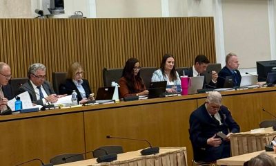 photo of a panel of people listening to a person give testimony.