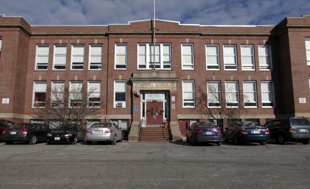 photo of a facade of an old brick two story school building.