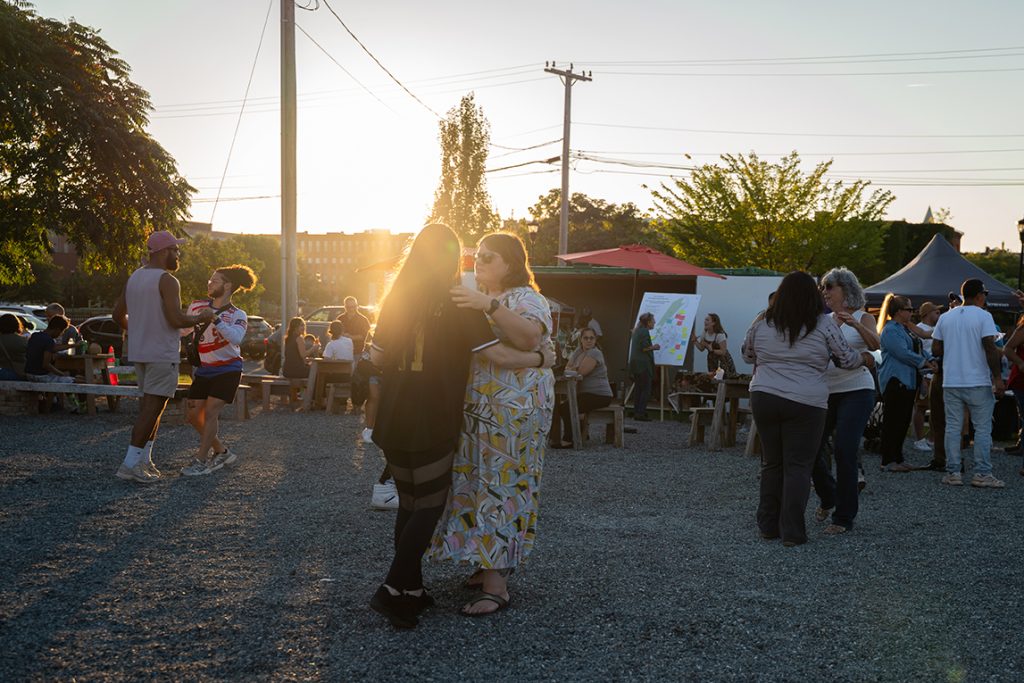 3 couples dancing outside as the sun goes down